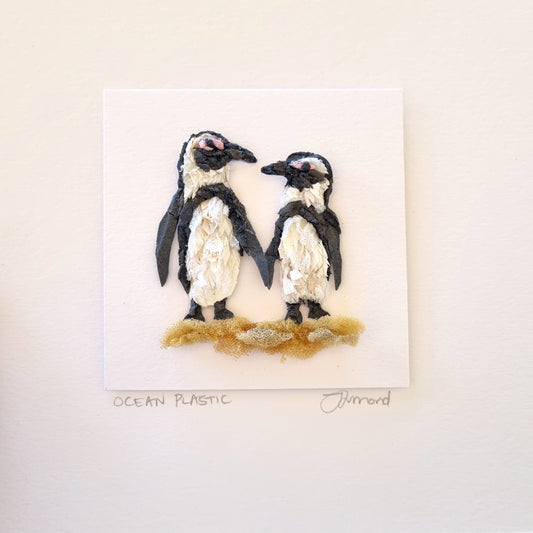 Penguin pair on sand