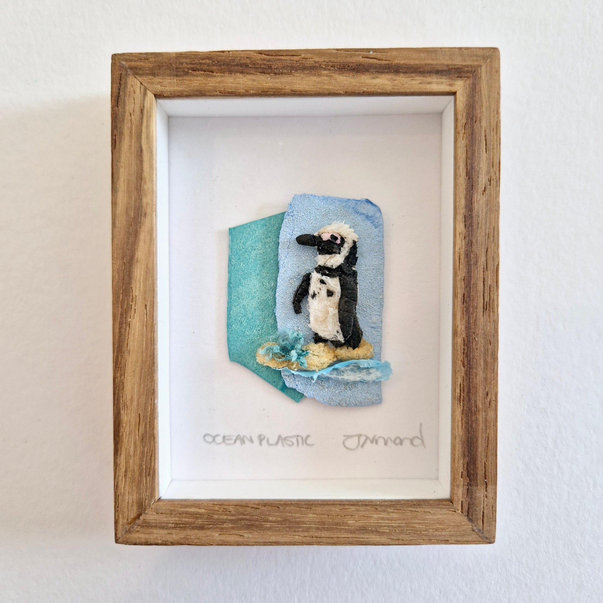 Framed Wall Art made from upcycled ocean plastic pollution by Janet Ormond  - penguin